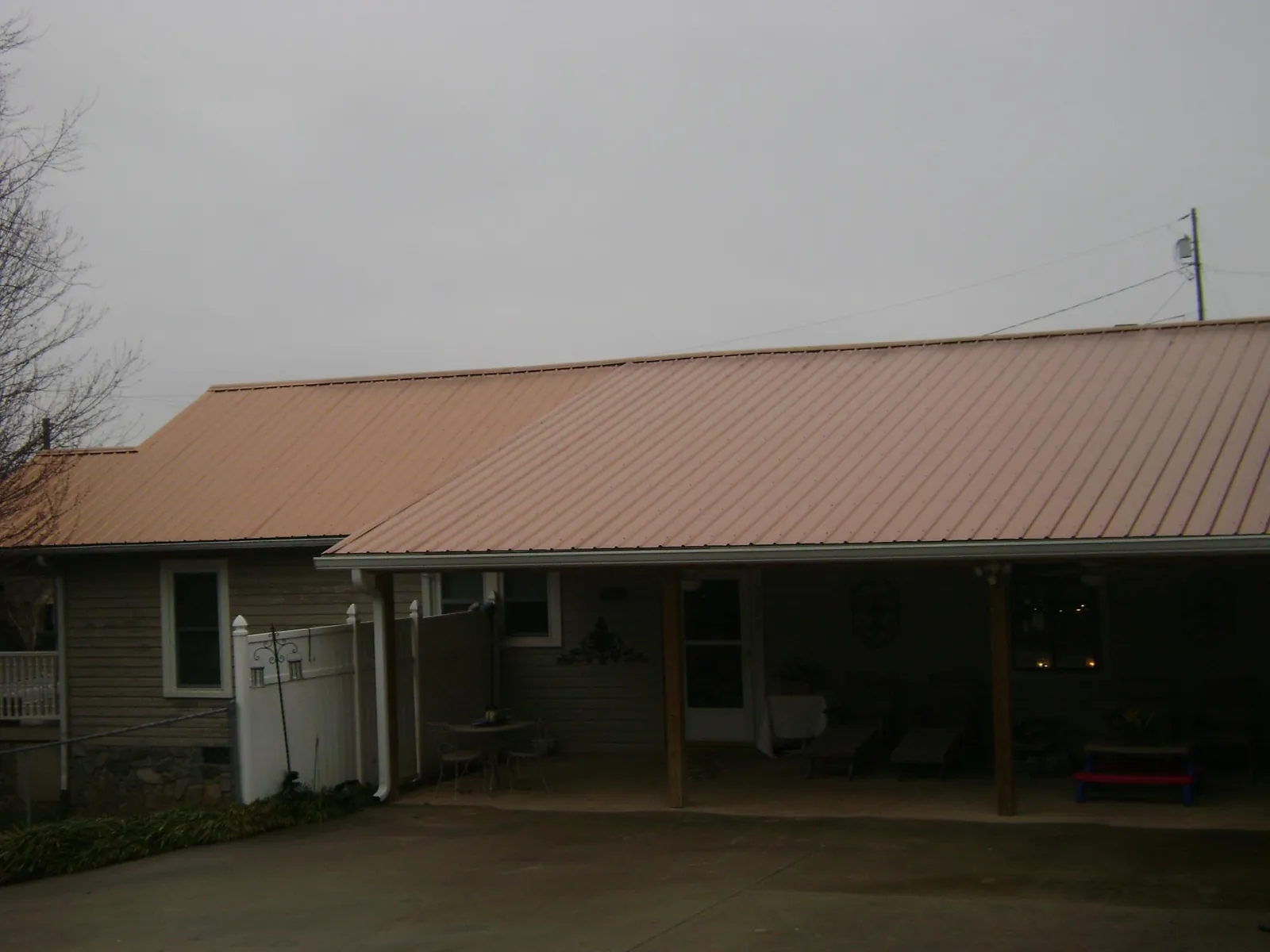 Copper toned metal roof over a wide covered patio in Burnet
